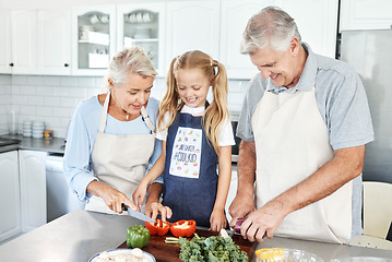 Image showing Grandparents, girl child in kitchen and cooking healthy food with vegetables on cutting board for happy family lunch at home. Natural, organic nutrition and clean diet for senior people in retirement