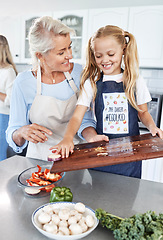 Image showing Children, family and cooking with a girl and grandmother preparing a meal in the kitchen of their home together. Food, love and learning with a senior woman teaching her granddaughter about cooking