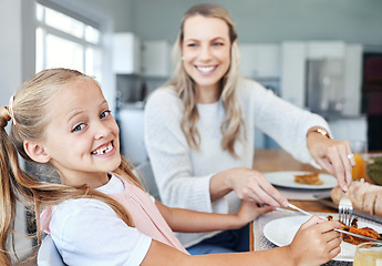 Image showing Food, family and mother and daughter eating at a kitchen table, happy, relax and bonding in their home. Love, portrait and girl learning etiquette, nutrition and sharing meal with a cheerful parent