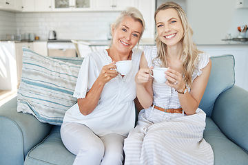 Image showing Family, tea and love with a woman and senior mother sitting on the living room sofa together during a home visit. Coffee, happy and smile with a mature female and adult daughter bonding in a house