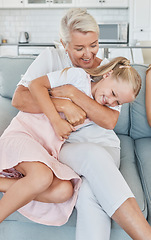 Image showing Grandmother, family and child at home with a senior woman having fun, bonding and laughing for tickle and playing on living room sofa. Grandma and girl grandchild spending time in Australia house