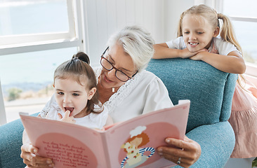 Image showing Book, family and children with a grandmother and girl kids reading a story in a home living room together. Retirement, love and learning with an elderly female and sister siblings bonding in a house