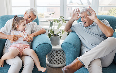Image showing Happy, grandfather and grandmother with child, excited and bonding being silly, goofy or funny in living room at home. Elderly man, senior woman or grandchild being playful, connect or laugh together