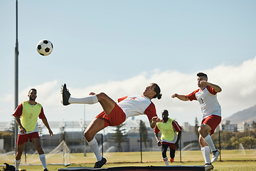 Image showing Sports, soccer and soccer player with team and soccer ball in power kick while playing on soccer field. Energy, fitness and football with football players competing in training, exercise and practice