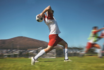 Image showing Training, man and soccer ball throw on soccer field during game or competition outdoor. Sports, fitness and football player pitching ball during practice, exercise or workout session on grass field