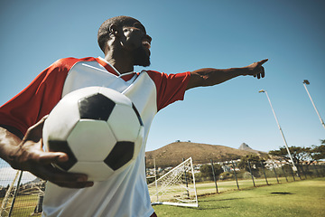 Image showing Soccer, football player and black man on a sports field with ball for game or match. Fitness, happy captain male and cardio training of an athlete outdoor for exercise with energy and motivation