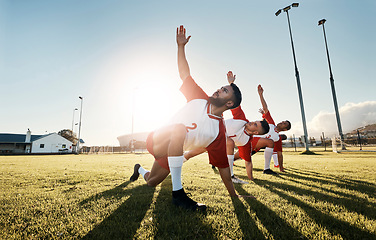 Image showing Soccer, football player and team stretching for sports match, training and practice of athlete men before game on outdoor field. Exercise, fitness and workout with male group ready for sport on grass