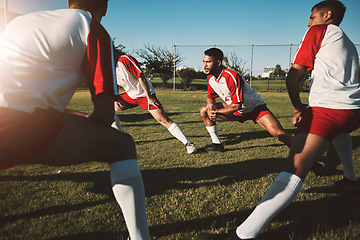 Image showing Soccer field, men and team stretching legs for match warm up, practice or game. Sports, football and group stretch outdoors on pitch in preparation for exercise, training or fitness workout on grass.