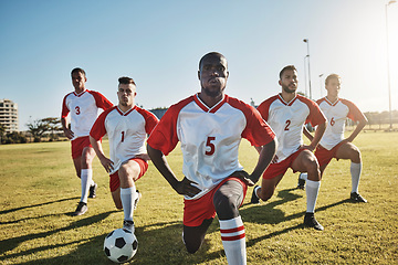 Image showing Soccer, men and team stretching on field before sports game or training exercise. Health, fitness and teamwork, football competition players stretch on grass together for strong performance in match.