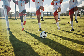 Image showing Football, soccer field and team stretching legs preparing for match, practice or game. Ball, sports and group of men outdoors on pitch getting ready for training, exercise or fitness workout outside.