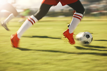 Image showing Soccer, sports and running with the shoes of a man athlete on a grass pitch or field during a game. Football, fitness and training with a male player dribbling during a match or cardio workout