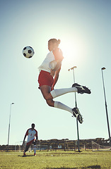Image showing Soccer, sports and training with a man athlete playing with a ball on a field or grass pitch for exercise and fitness. Football, jumping and workout with a male in a game or match for sport