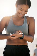 Image showing Fitness, smartwatch and training with black woman in outdoor for running, health and sports workout. Exercise, energy and time with girl and technology for lifestyle, wellness and performance monitor