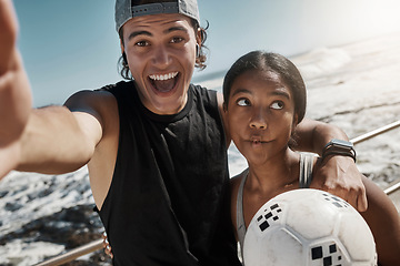Image showing Soccer ball, couple and fun sports selfie by beach, sea or ocean after fitness, workout and training. Portrait, smile and happy man and comic woman in photograph pov after football exercise in Brazil