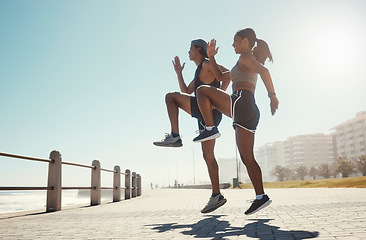 Image showing Fitness, nature and couple exercise in beach park, jump wellness and outdoor cardio workout on promenade. Motivation, health and sport partnership or friends in sports training or active lifestyle