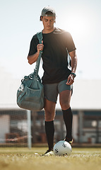 Image showing Football, training and exercise man with ball on sport field after training, practice and workout with bag. Athlete, soccer and fitness on sports ground after healthy sports cardio outdoor in summer