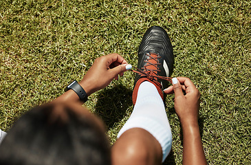 Image showing Shoes tie, sports and soccer black woman athlete on green grass ready for exercise and training. Fitness, workout and game of a healthy person player before football cardio in nature and summer