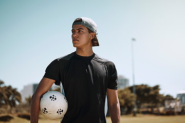 Image showing Soccer, sports and training with a man athlete holding a ball on a grass pitch or field before a game. Fitness, football and exercise with a male player thinking about a match outside during summer