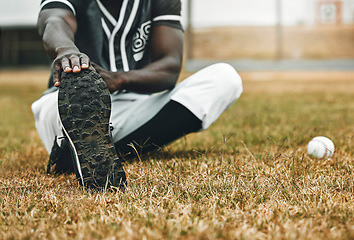 Image showing Baseball player, stretching legs and athlete black man on sports field doing warm up exercise, workout and practice for match. Fitness male touch feet for health, wellness and energy on outdoor pitch