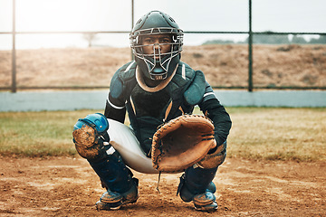 Image showing Baseball, catcher and sports with man on field at pitchers plate for games, fitness and health in stadium park. Helmet, glove and uniform with athlete training for workout, achievement and exercise