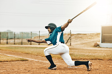 Image showing Baseball, sports and homerun with a man athlete or batter hitting and scoring during a game outdoor on a pitch. Sport, fitness and exercise with a male player on a field for training or a match