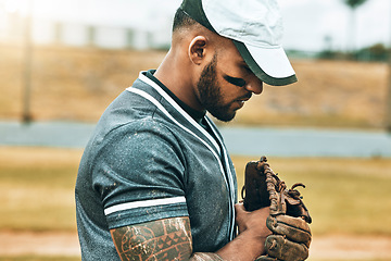Image showing Man, baseball and glove with focus, game and determination as fielder, pitcher or baseball player. Athlete, sport and training for wellness, fitness and health in competition, sports or match outdoor