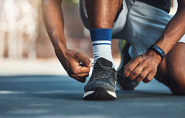 Image showing Fitness, hands or black man tie shoes lace before start of running exercise, fitness training or sports workout. Health, wellness and legs of marathon runner, athlete or person prepare for cardio run