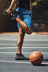 Image showing Fitness, basketball and man stretching legs on outdoor court for muscle preparation with workout. Muscular, strong and athlete male with standing warm up for sports game training exercise.