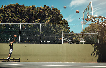 Image showing Basketball, sports and net with a man athlete playing on a court for training, fitness or exercise. Healyh, wellness and workout with a male player practicing his shot to score for a game or match