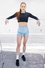 Image showing Portrait, fitness and woman training in the city for health, cardio and exercise. Young athlete girl with focus, determination and motivation in the urban road or street for a sports workout