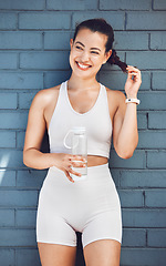 Image showing Fitness, exercise and water with a sports woman taking a drink during a break from her training workout. Health, cardio and hydration with a female athlete or runner thinking about her wellness