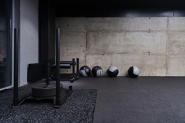 Image showing An empty modern gymnasium with a variety of equipment, offering a spacious, functional, and well-equipped training facility for workouts, fitness, and strength training