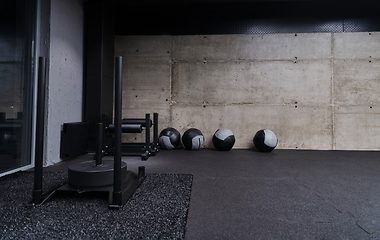 Image showing An empty modern gymnasium with a variety of equipment, offering a spacious, functional, and well-equipped training facility for workouts, fitness, and strength training