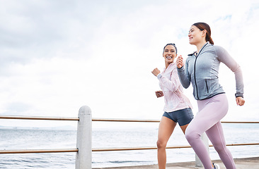 Image showing Running, fitness and friends, women run by the beach, exercise and cardio, endurance and active lifestyle. Young, happy people, runner and health, body training motivation and workout outdoors.