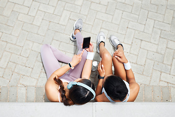 Image showing Smartphone, headphones and fitness friends listening to music, exercise podcast and health app for outdoor motivation. Relax sports people using phone for social media workout tips or blog app above