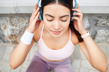 Image showing Yoga, headphones and woman listening to music for zen, calm and peace meditation in the city. Health, fitness and girl from Canada doing a pilates exercise with wellness audio, podcast or radio.