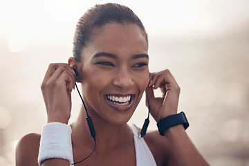 Image showing Music, fitness and exercise with a woman runner streaming audio while outdoor for training or workout. Running, sports and health with a female athlete listening on earphones during a cardio run