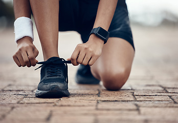 Image showing Running sneakers, fitness and woman athlete tie lace in outdoor cardio exercise training. Mock up of young sports person fix trainers before wellness run, cardio jog or marathon training in city