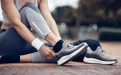 Image showing Shoes, fitness and exercise with a sports woman or running getting ready for a workout on the sidewalk outdoor. Training, health and cardio with a female athlete or runner preparing for a routine run