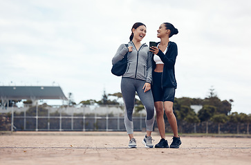 Image showing Fitness, friends and women laugh at phone while walking to gym, fun and workout goals with personal trainer. Health, exercise and happy woman with friend reading funny message on social media outside