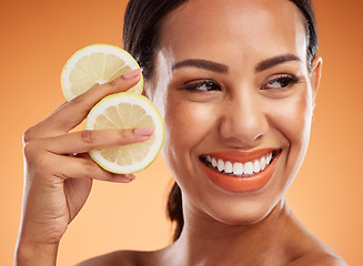 Image showing Orange, skincare or beauty makeup woman for facial, cosmetics or health wellness in studio. Skin, happy model or vitamin c with young girl holding fruit for healthy nutrition or natural face portrait