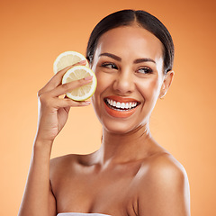 Image showing Face, skincare and woman with lemon for health, wellness and vitality on orange studio background. Model, smile and female from Canada with citrus fruit for healthy vitamin c, minerals or nutrition.