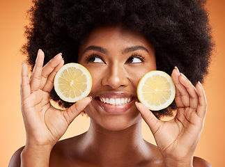 Image showing Beauty, skincare and black woman with lemon in hands and smile on face posing for organic, healthy and natural ingredients in skincare products. Facial, body care and wellness for spa detox treatment