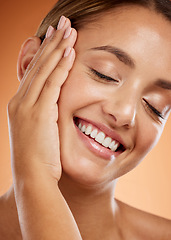 Image showing Woman, face and hand with smile for skincare beauty and relax in luxury treatment against studio background. Closeup of a beautiful happy female smiling with teeth in satisfaction for perfect skin