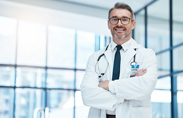 Image showing Doctor, man and happy with arms crossed in hospital for medical, career and happiness for portrait. Medic, smile and work in clinic for healthcare, wellness and health while working in Washington DC