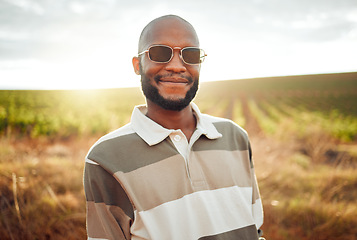Image showing Fashion, farm and agriculture with a black man farmer outdoor in the summer sun in sunglasses. Sustainability, farming and style with a handsome young male outside on a green meadow or field of grass