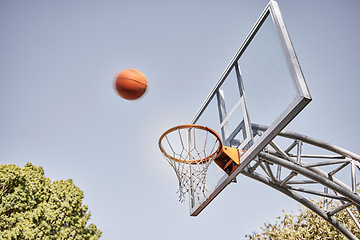 Image showing Basketball net, ball and outdoor sports goals, competition game and action on sky background. Background basketball court, shooting hoops and winning target, training skill and fun performance in air