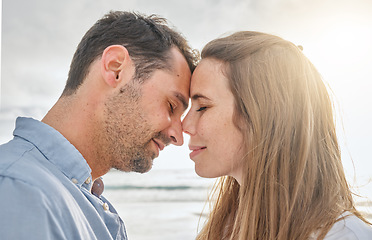 Image showing Travel, love and couple relax at sunset, embracing in intimate moment on a beach vacation in Florida. Happy, face and caring man relaxing with woman in Mexico, enjoy romance and ocean trip together