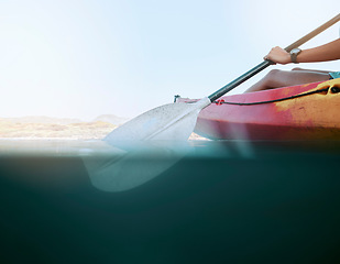 Image showing Lake, water sport and woman on kayak summer adventure, travel or trip canoeing, kayaking and using paddle on calm sea. Exercise, vacation or holiday with female enjoying healthy boat activity