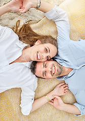 Image showing Couple, travel and beach date portrait of woman and man relax, bond and lying on a blanket in the sand. Love, romance and tropical vacation with lovers enjoying peaceful day at the ocean together